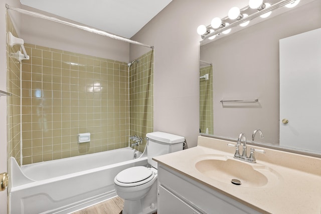 full bathroom featuring vanity, toilet, hardwood / wood-style floors, and tiled shower / bath