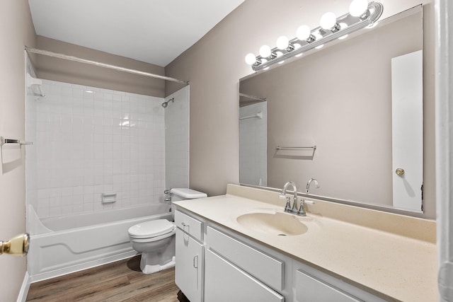 full bathroom featuring vanity, toilet, tiled shower / bath combo, and wood-type flooring