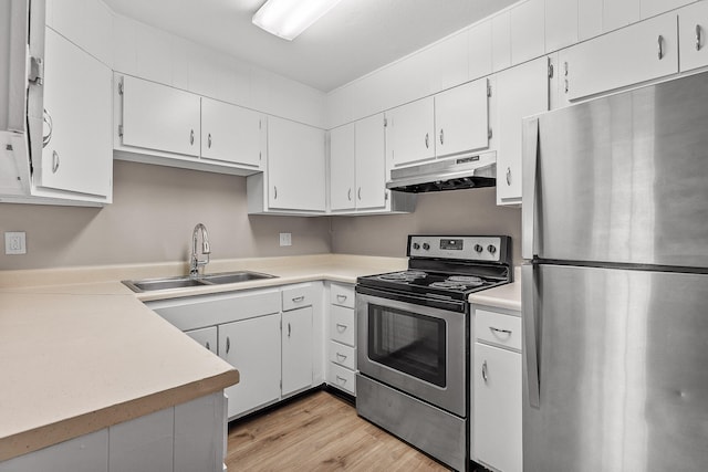 kitchen with light hardwood / wood-style floors, white cabinets, stainless steel appliances, and sink