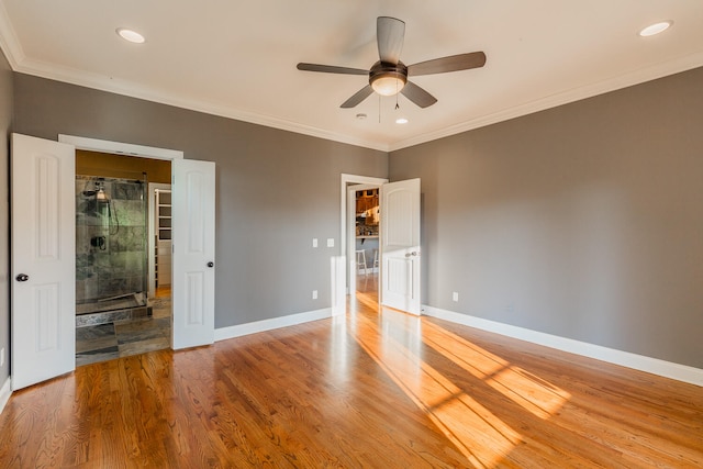 unfurnished bedroom with ornamental molding, hardwood / wood-style flooring, and ceiling fan