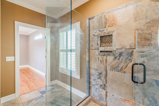 bathroom featuring ornamental molding, an enclosed shower, and hardwood / wood-style floors