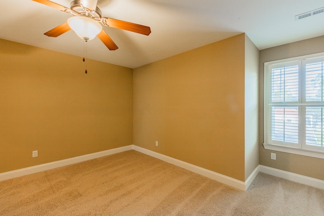 empty room with ceiling fan and carpet