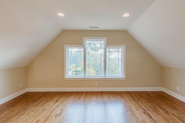 bonus room with vaulted ceiling and light hardwood / wood-style flooring