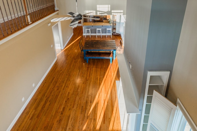 staircase featuring hardwood / wood-style floors and ceiling fan