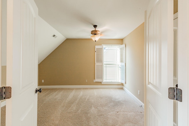 bonus room with ceiling fan, vaulted ceiling, and light colored carpet