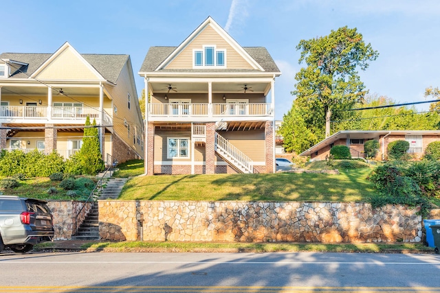 view of front of property with ceiling fan and a balcony