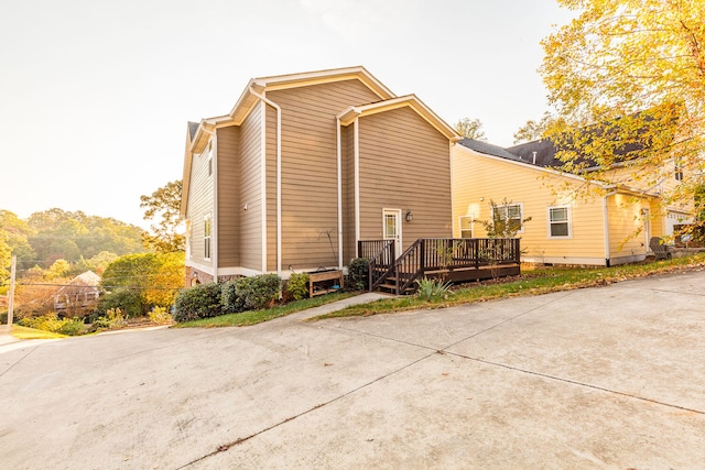 view of property exterior with a deck