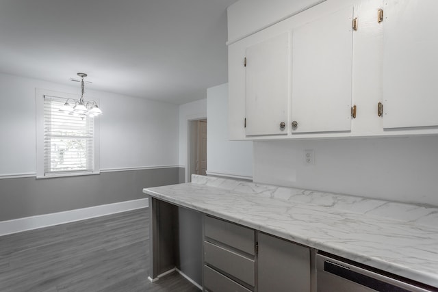 kitchen with dark hardwood / wood-style flooring, decorative light fixtures, an inviting chandelier, dishwasher, and white cabinets