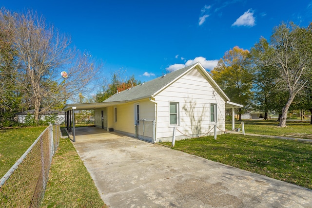 exterior space featuring a lawn and a carport