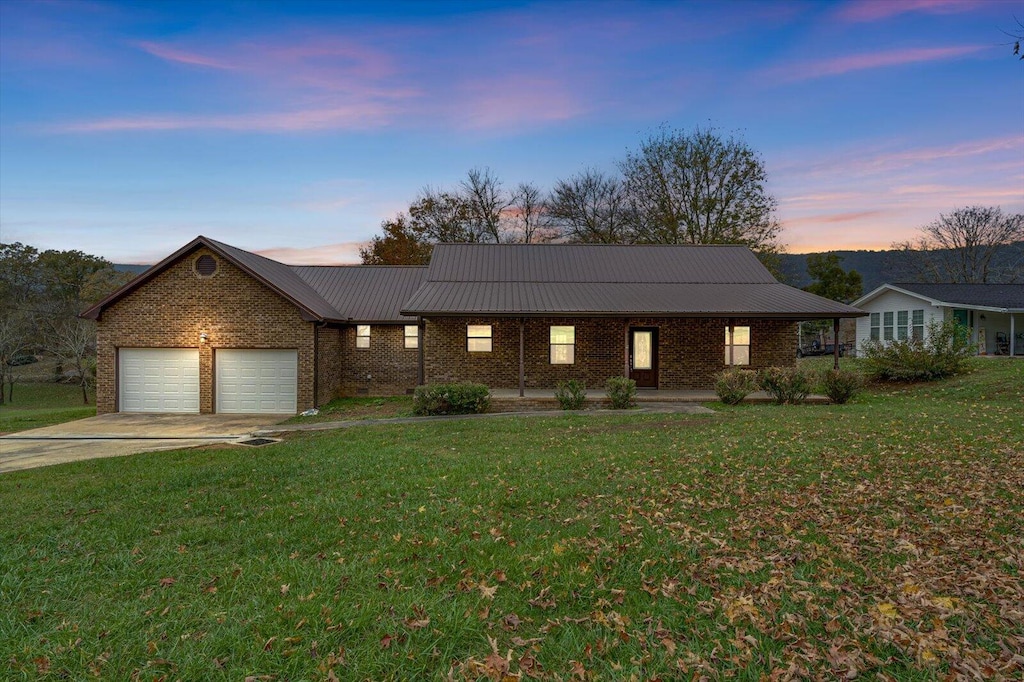 view of front facade with a garage and a lawn