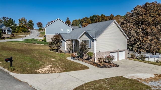 view of front of house featuring a garage and a front lawn