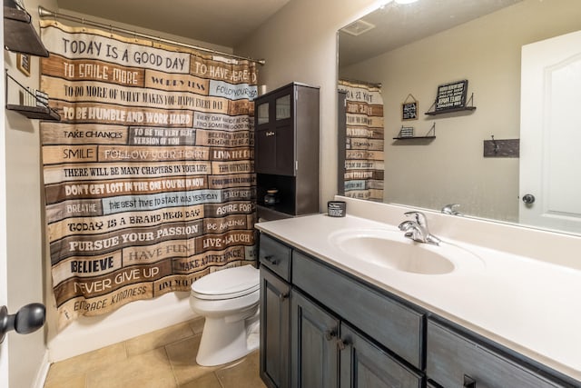 full bathroom featuring tile patterned floors, shower / bathtub combination with curtain, vanity, and toilet