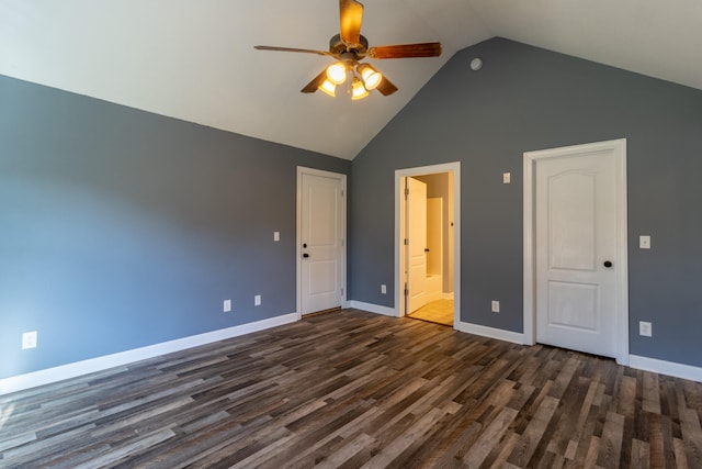 unfurnished bedroom featuring ceiling fan, dark wood-type flooring, high vaulted ceiling, and ensuite bath