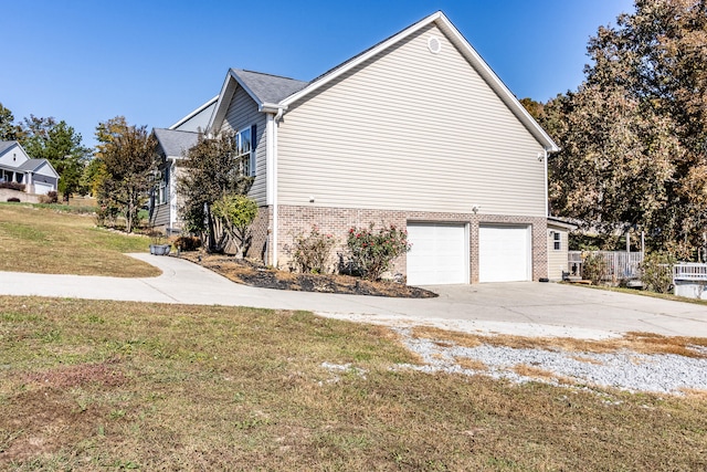 view of property exterior with a lawn and a garage