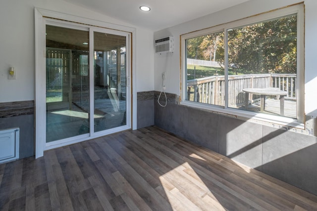 unfurnished sunroom with a wall mounted AC