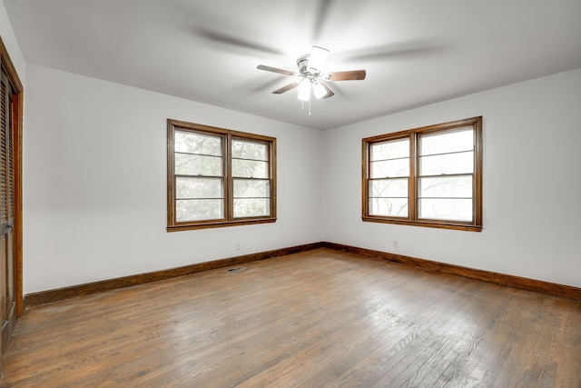 unfurnished room featuring hardwood / wood-style floors, ceiling fan, and plenty of natural light