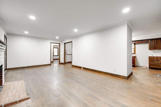 unfurnished living room with ornamental molding, light hardwood / wood-style floors, and a fireplace