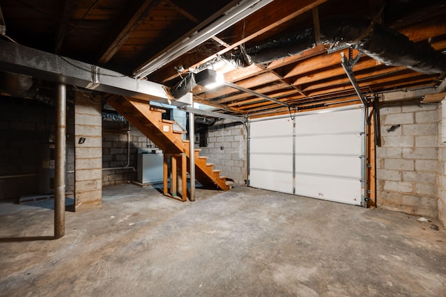 garage with a garage door opener and washer / dryer