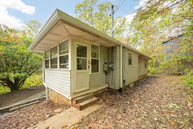 view of outbuilding with a sunroom