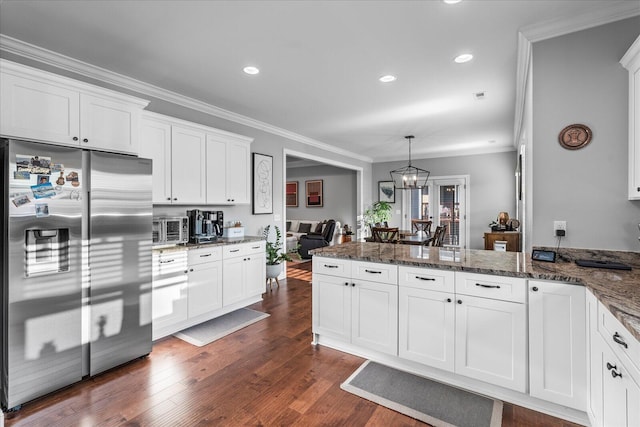 kitchen featuring stainless steel fridge, decorative light fixtures, white cabinets, dark wood-type flooring, and ornamental molding