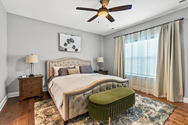 bedroom with ceiling fan and dark hardwood / wood-style flooring