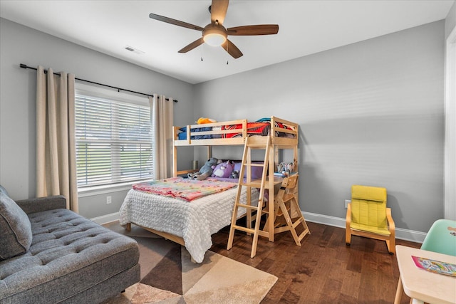 bedroom with ceiling fan and dark hardwood / wood-style flooring