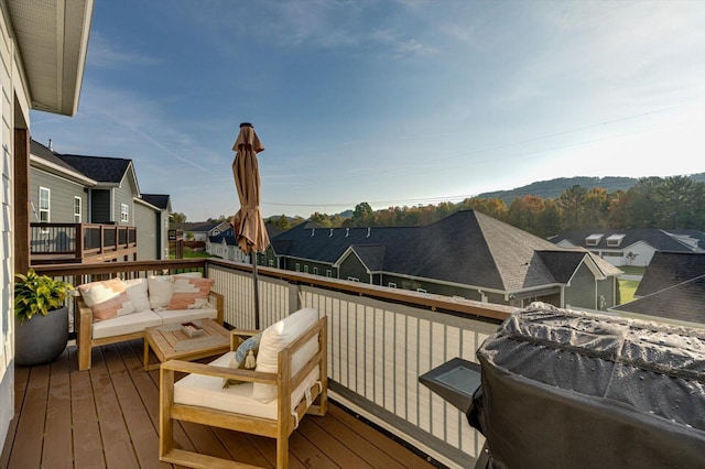 wooden terrace featuring an outdoor living space