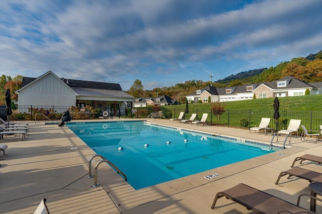 view of pool featuring a patio and a lawn