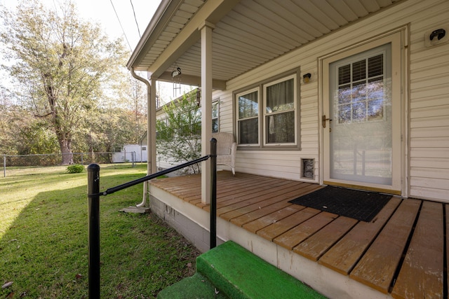 wooden terrace featuring a yard