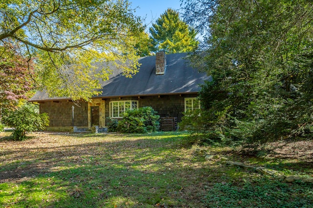 back of house with a lawn