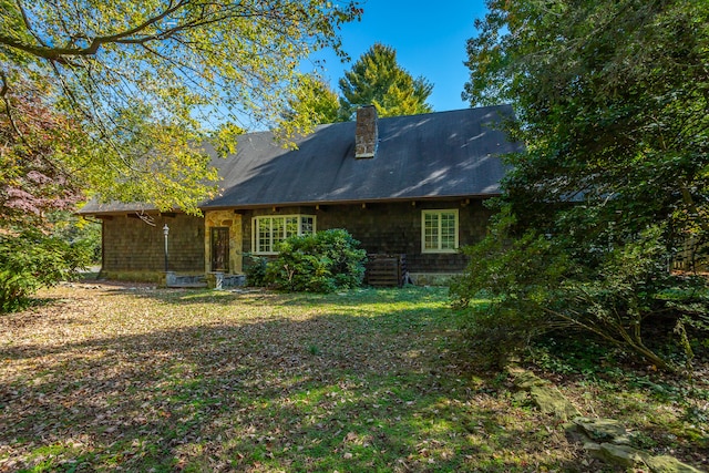 rear view of house with a lawn