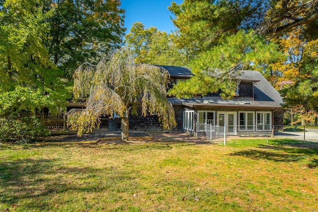 rear view of house featuring a patio and a lawn