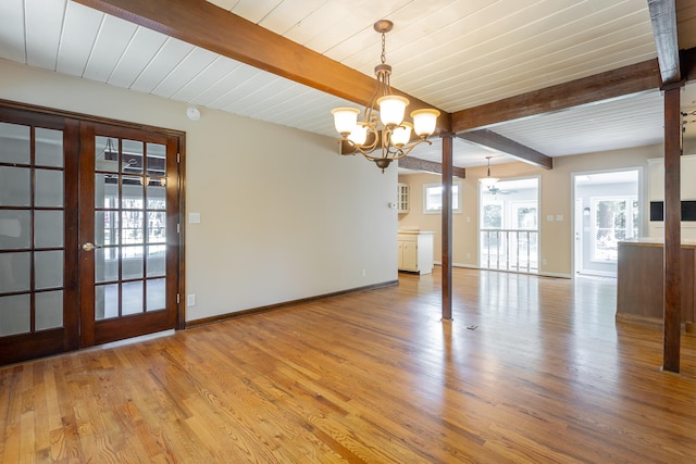 interior space featuring beamed ceiling, french doors, ceiling fan with notable chandelier, and light hardwood / wood-style floors