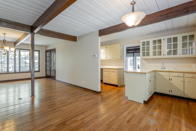 kitchen with a healthy amount of sunlight, light hardwood / wood-style flooring, and pendant lighting