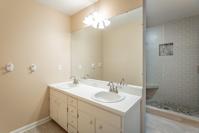 bathroom featuring vanity, hardwood / wood-style floors, and tiled shower