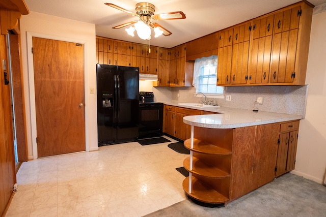 kitchen featuring kitchen peninsula, backsplash, sink, black appliances, and ceiling fan