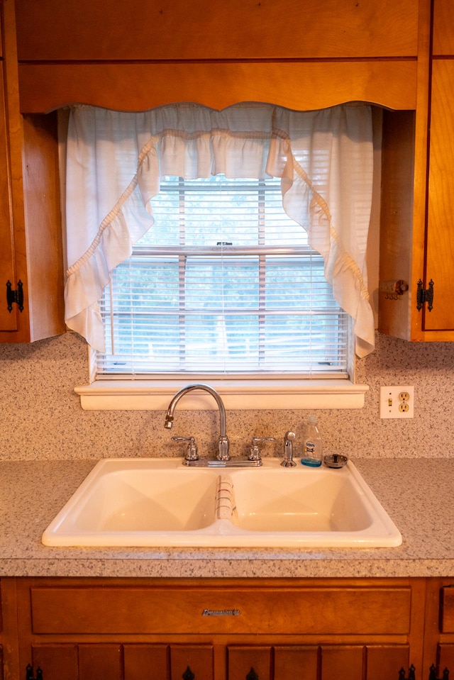 interior details with sink and decorative backsplash