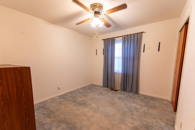 empty room with ceiling fan and carpet flooring