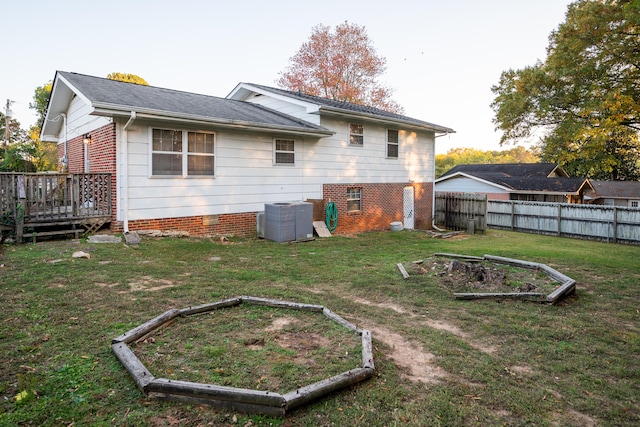 back of property featuring a wooden deck, a yard, and central air condition unit