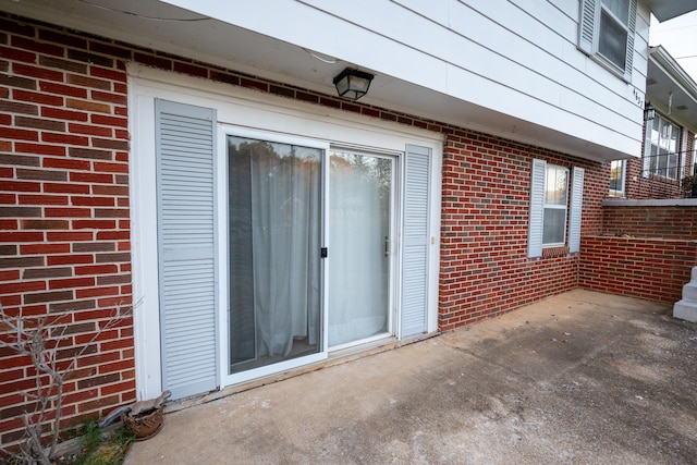 entrance to property featuring a patio area