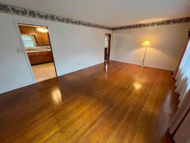 spare room with light hardwood / wood-style flooring and sink