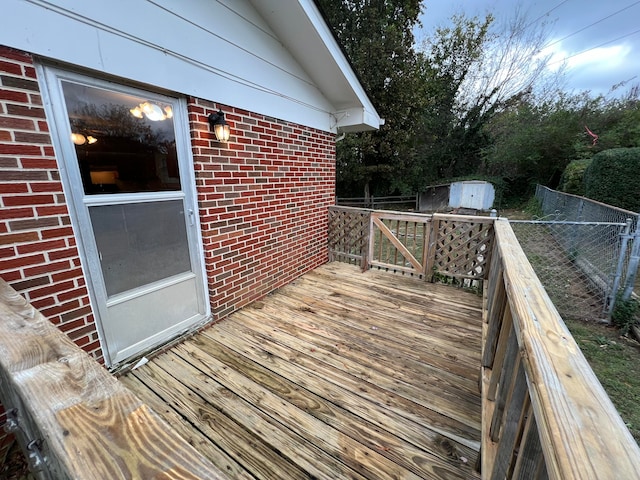 wooden terrace featuring a storage shed