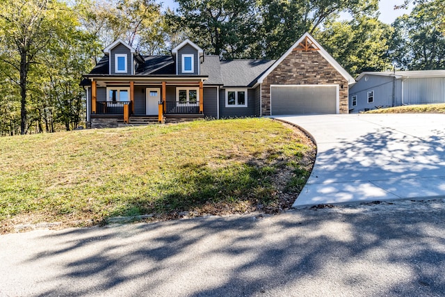 cape cod home featuring covered porch, a garage, and a front lawn