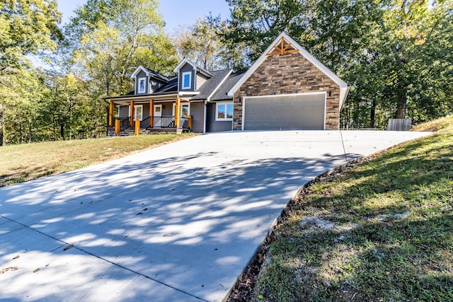 view of front facade featuring covered porch, a front lawn, and a garage