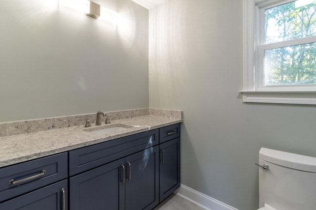 bathroom featuring toilet and vanity