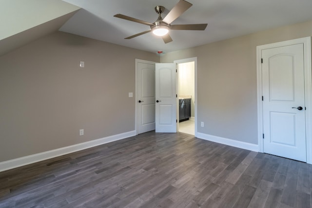 unfurnished bedroom with connected bathroom, ceiling fan, and dark hardwood / wood-style flooring