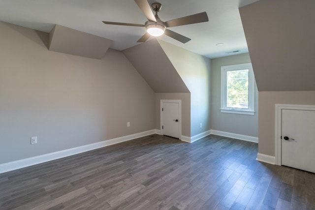 additional living space featuring dark wood-type flooring, vaulted ceiling, and ceiling fan