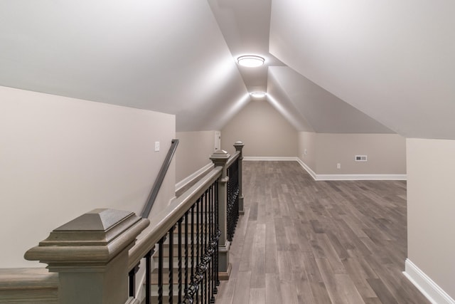 bonus room with vaulted ceiling and hardwood / wood-style flooring