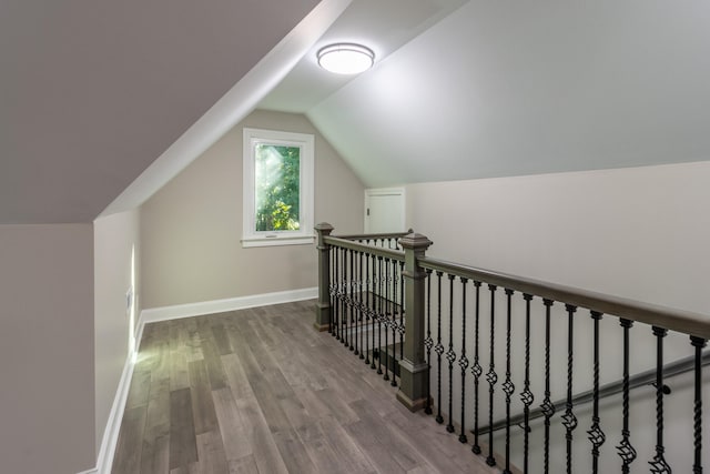 interior space featuring hardwood / wood-style flooring and vaulted ceiling