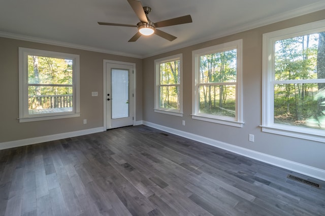 interior space with ornamental molding, ceiling fan, and dark hardwood / wood-style flooring